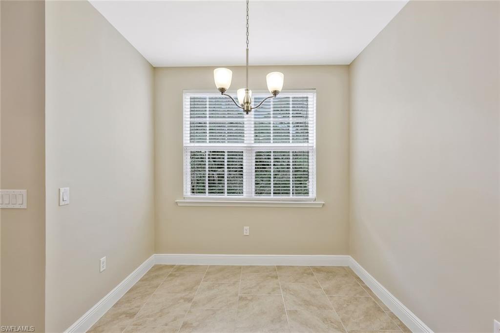 18225 Creekside Preserve Loop, Unit 102 Fort Myers, FL 33908 - Photo 7 of 25 Unfurnished dining area with a chandelier and baseboards
