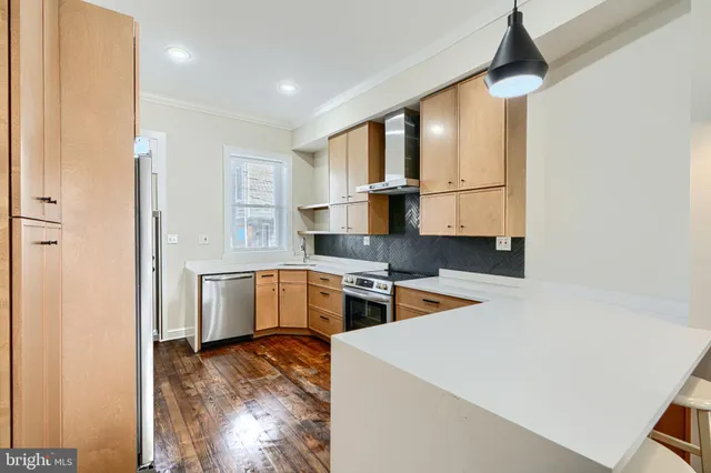 a view of a kitchen with refrigerator and cabinet