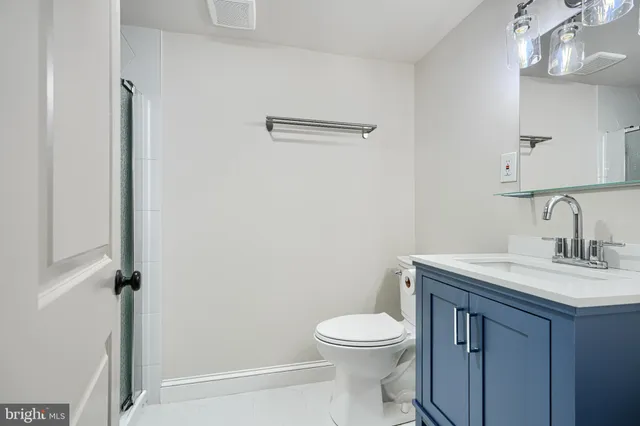 a bathroom with a toilet and a shower curtain