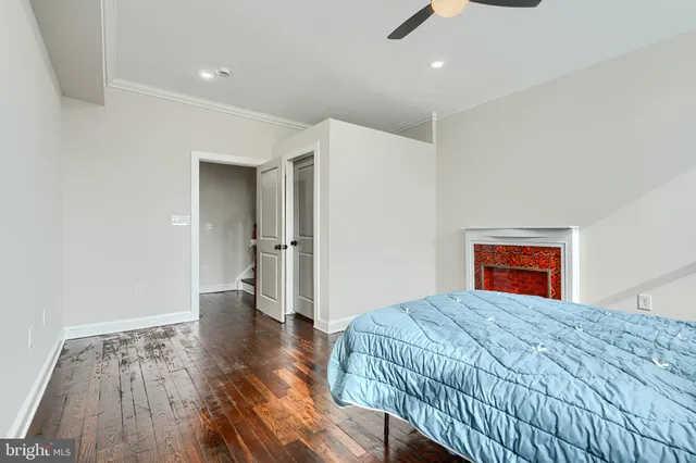 a view of a hallway with wooden floor and a dining space