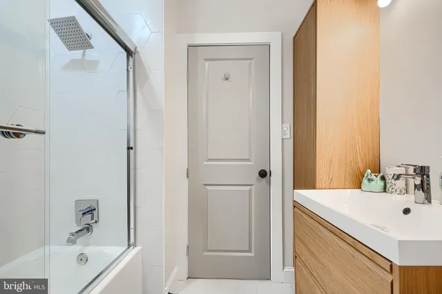 a view of a balcony with dining table & chairs