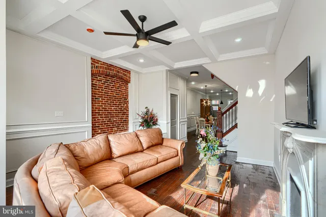 a dining room with furniture entryway and wooden floor