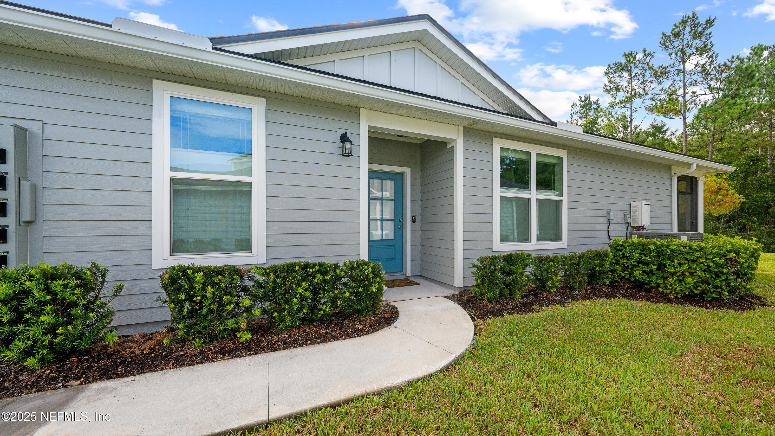 327 Charlie Way St. Augustine, FL 32095 - Photo 3 of 22 a front view of a house with garden