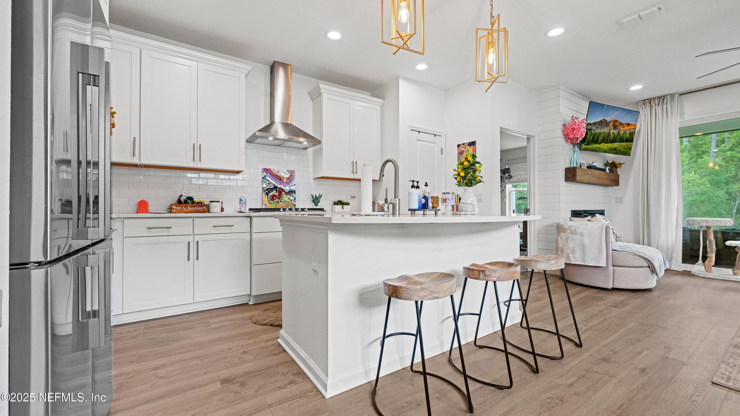 327 Charlie Way St. Augustine, FL 32095 - Photo 6 of 22 a kitchen with white cabinets and wooden floor
