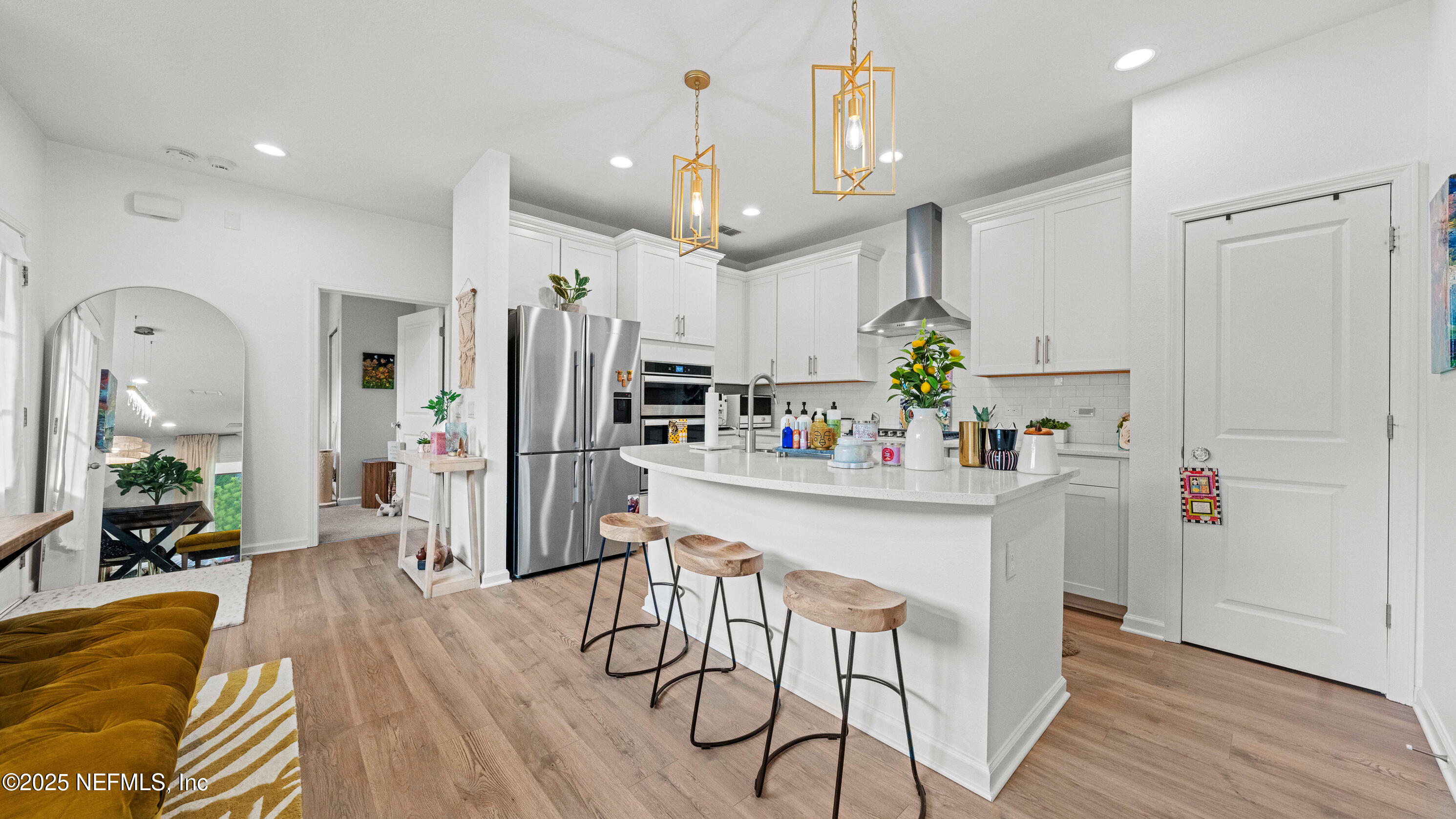 327 Charlie Way St. Augustine, FL 32095 - Photo 8 of 22 a kitchen with stainless steel appliances a refrigerator a sink dishwasher a stove and white cabinets with wooden floor