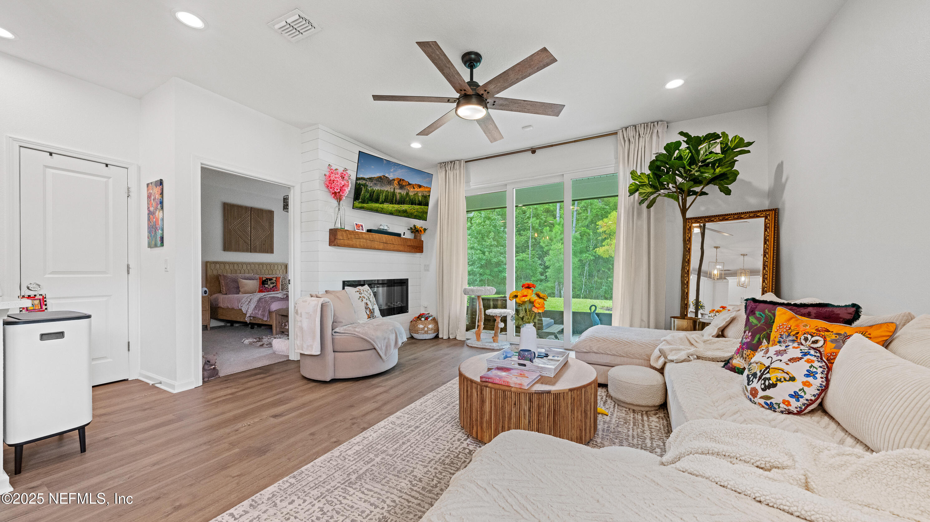 327 Charlie Way St. Augustine, FL 32095 - Photo 10 of 22 a living room with fireplace furniture and a large window