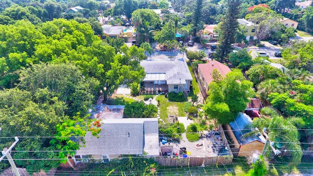 an aerial view of a house with a yard and garden