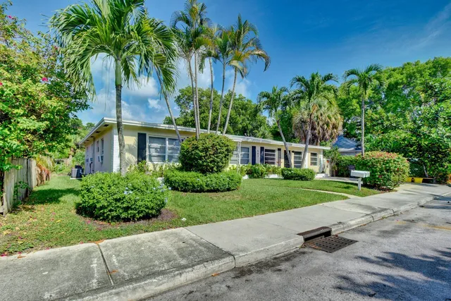 a view of a house with a yard and tree s