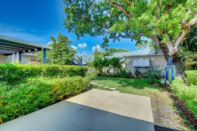 a view of house with outdoor space and garden