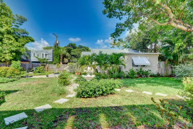 a view of a house with a yard and garden