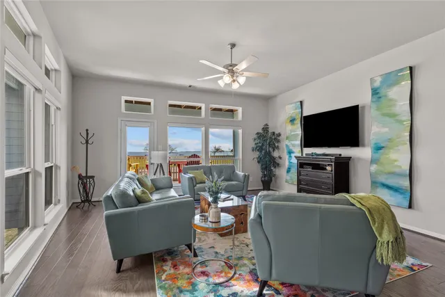 a living room with furniture a flat screen tv and a fireplace