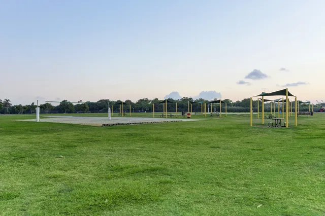 a view of a green field with wooden fence