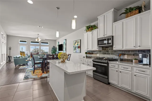 a view of kitchen with sink and cabinets