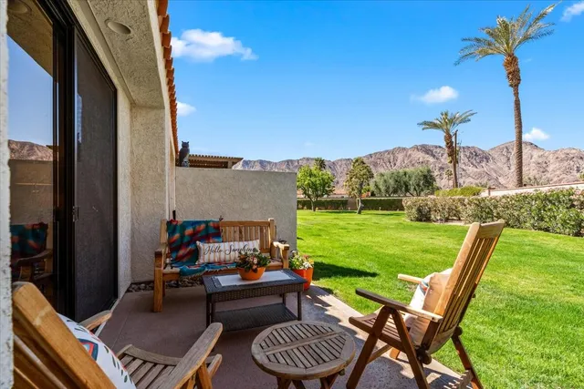 a view of a house with a backyard porch and sitting area