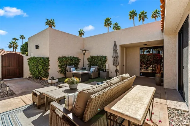 a view of a patio with table and chairs with potted plants
