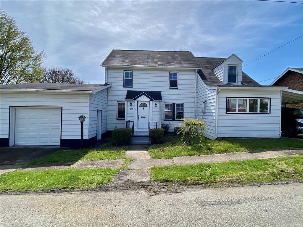 116 Nassau Street Uniontown, PA 15401 - Photo 1 of 25 a front view of a house with a yard and garage