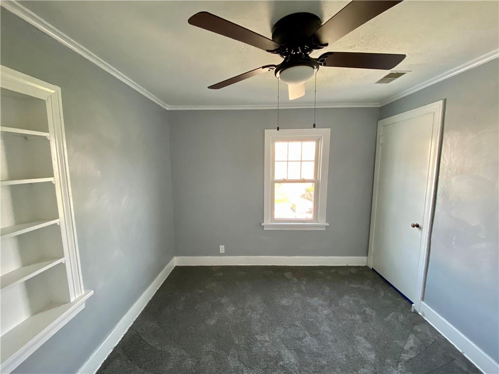 116 Nassau Street Uniontown, PA 15401 - Photo 17 of 25 an empty room with a ceiling fan and window