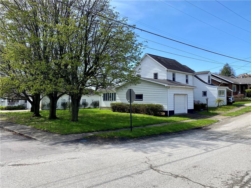 116 Nassau Street Uniontown, PA 15401 - Photo 2 of 25 a front view of a house with a yard and garage