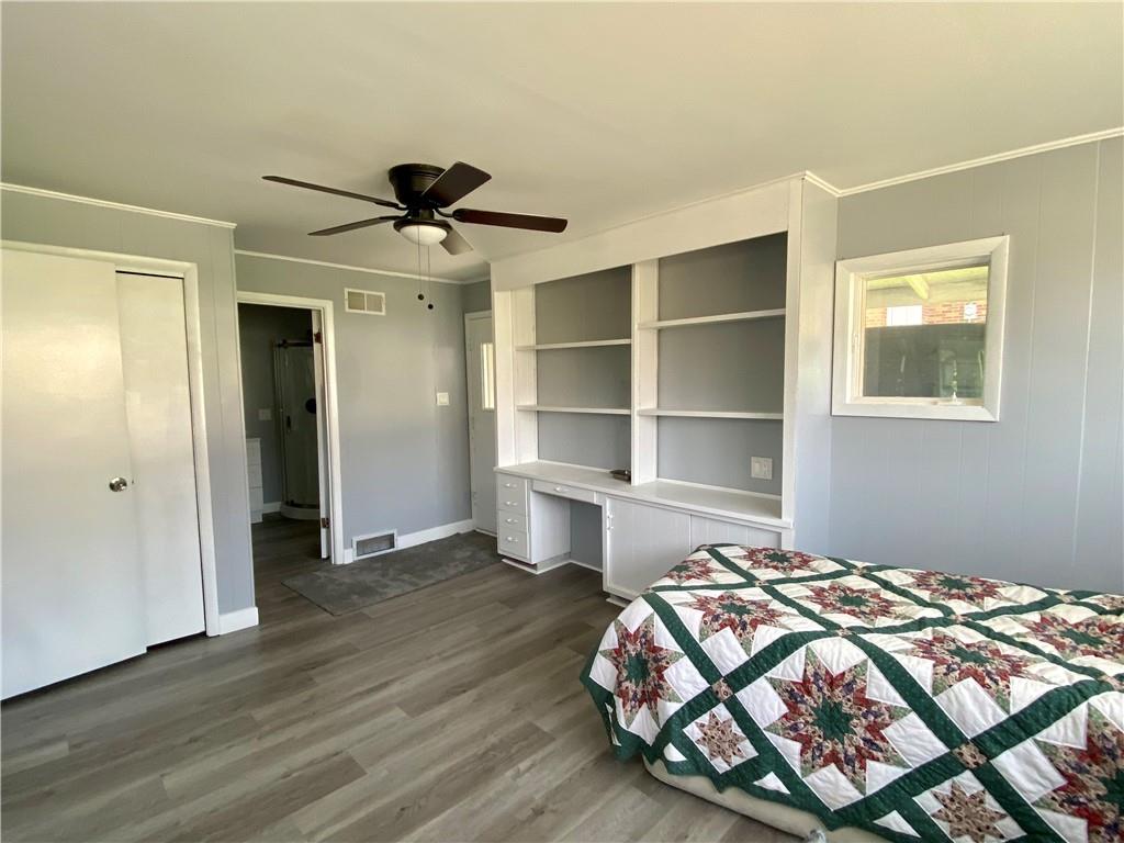 116 Nassau Street Uniontown, PA 15401 - Photo 9 of 25 a bedroom with a bed and a chandelier