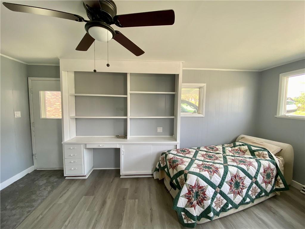 116 Nassau Street Uniontown, PA 15401 - Photo 10 of 25 a bedroom with a bed and a chandelier
