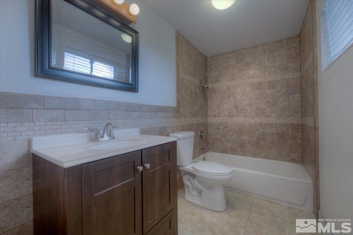 1660 Carlin Street Reno, NV 89503 - Photo 16 of 27 a bathroom with a sink a toilet and shower