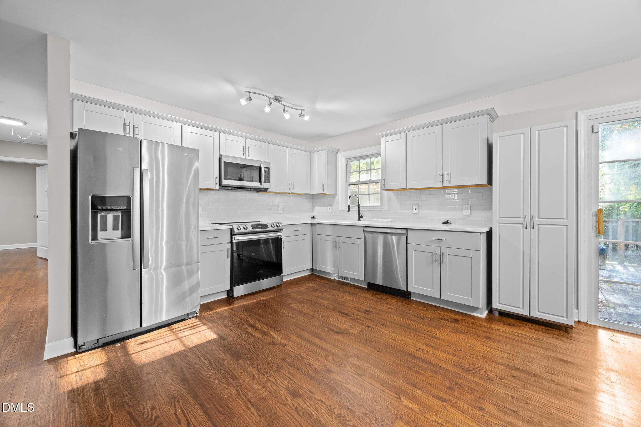 2950 Glenridge Drive Raleigh, NC 27604 - Photo 8 of 53 a kitchen with stainless steel appliances a refrigerator sink and cabinets