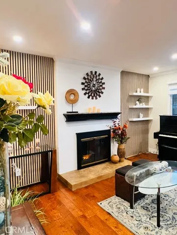a living room with a fireplace and a kitchen view