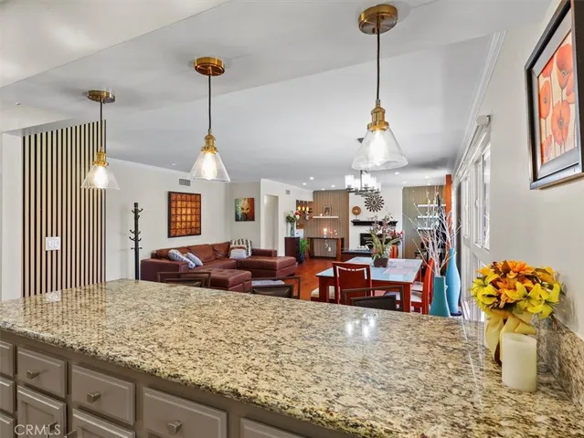 a living room with fireplace furniture and a chandelier