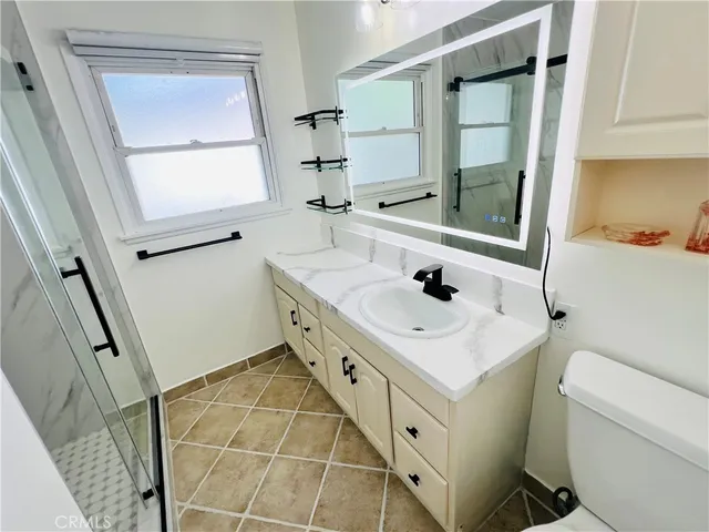 a bathroom with a sink toilet and mirror