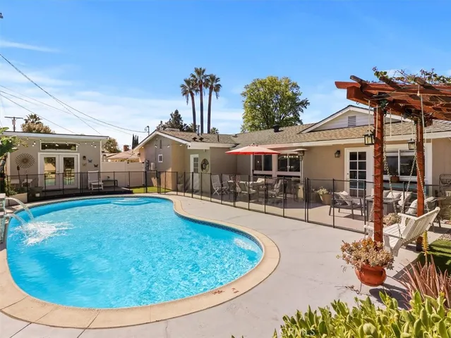 a view of a house with swimming pool and porch