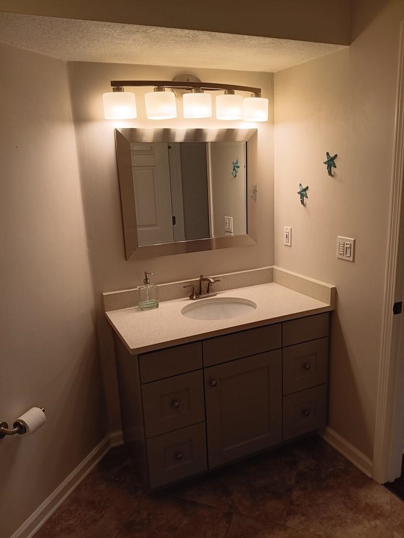 1300 Vista Cove Road St. Augustine, FL 32084 - Photo 14 of 21 a bathroom with a sink and a mirror