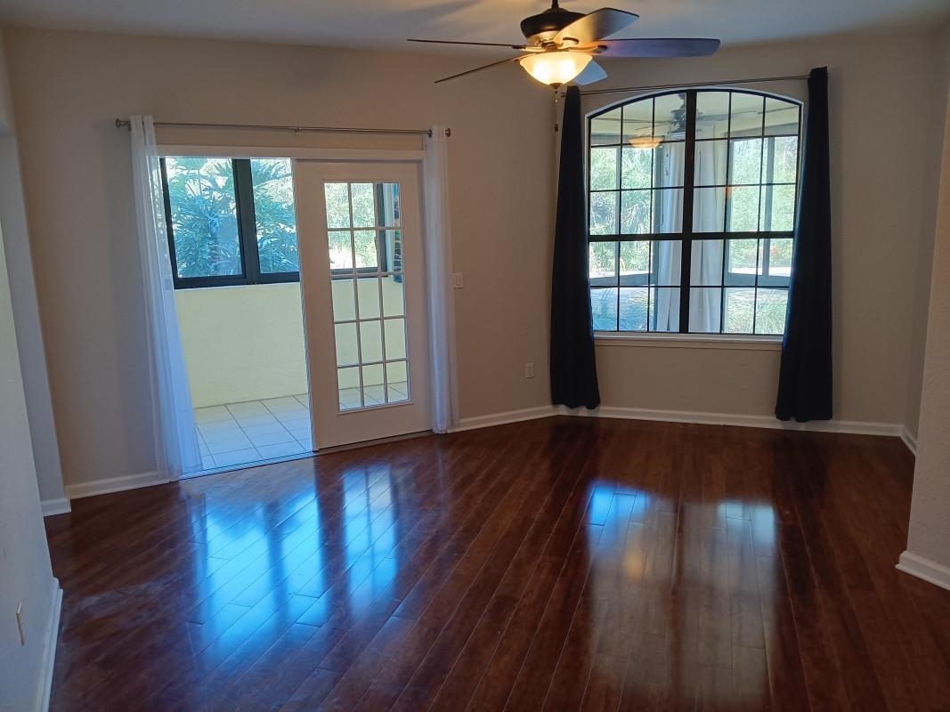 1300 Vista Cove Road St. Augustine, FL 32084 - Photo 3 of 21 a view of empty room with wooden floor and fan