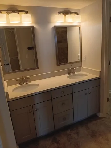 a bathroom with a double vanity sink and mirror
