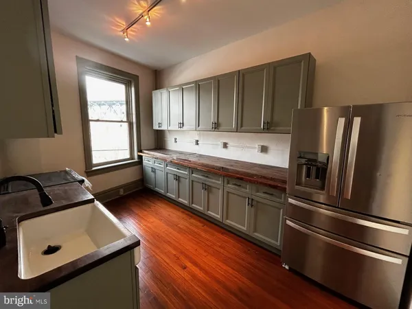a kitchen with a refrigerator and a sink