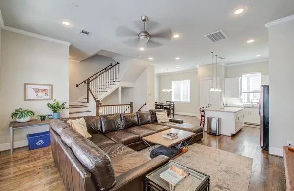 a living room with fireplace furniture and a wooden floor