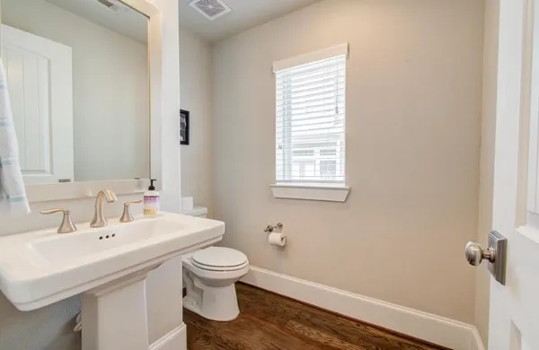 a bathroom with a sink toilet and a mirror