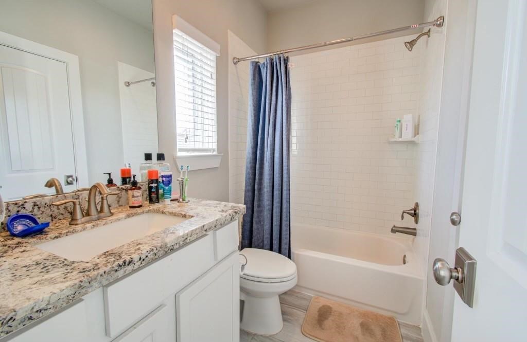 243 West 27th Street Houston, TX 77008 - Photo 17 of 31 a bathroom with a granite countertop sink toilet and shower