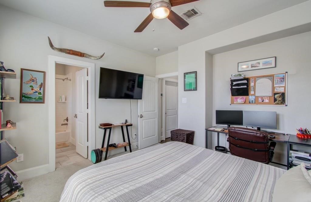 243 West 27th Street Houston, TX 77008 - Photo 18 of 31 a bedroom with a bed and a flat screen tv