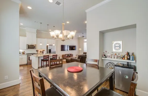 a kitchen with kitchen island stainless steel appliances a dining table and chairs