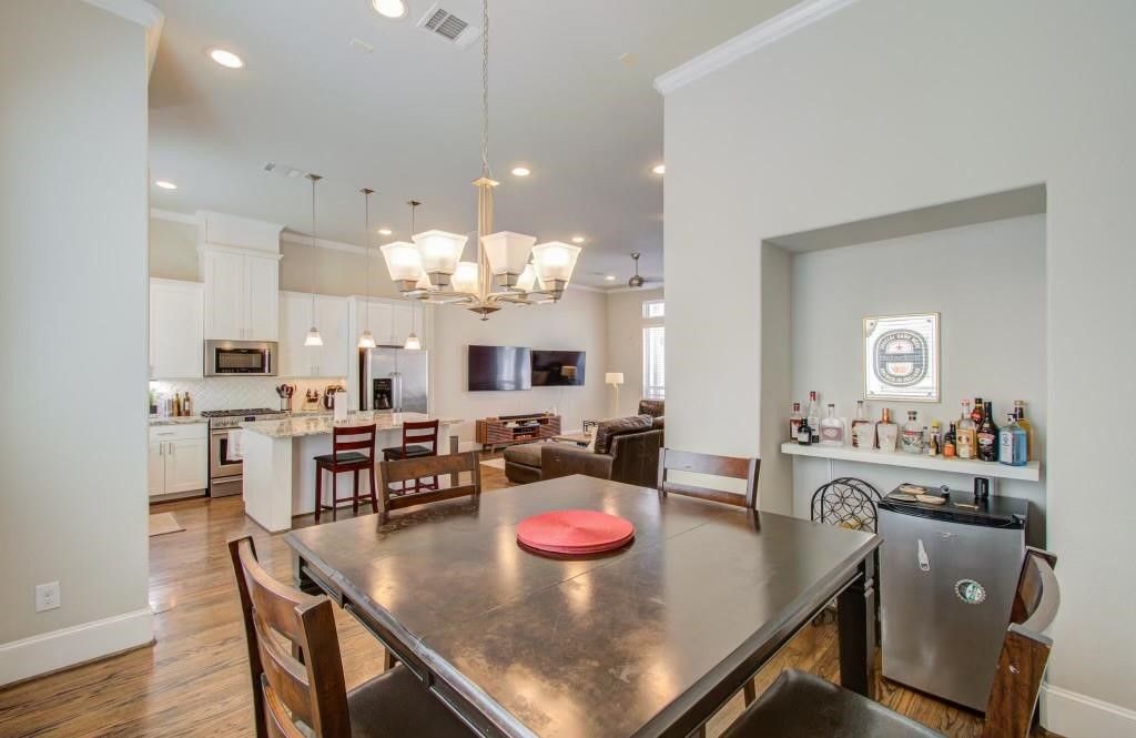 243 West 27th Street Houston, TX 77008 - Photo 23 of 31 a kitchen with kitchen island stainless steel appliances a dining table and chairs