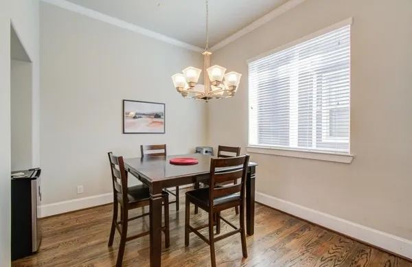 a dining room with furniture and window