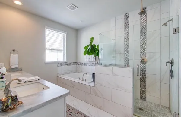a bathroom with a sink a bathtub and a window