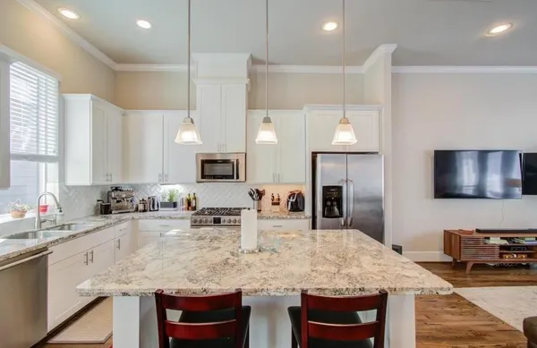 a kitchen with kitchen island granite countertop a sink and counter space