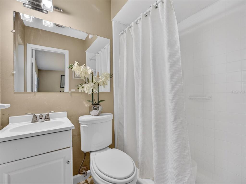 2803 Banchory Road Winter Park, FL 32792 - Photo 16 of 31 a bathroom with a sink a toilet and a mirror