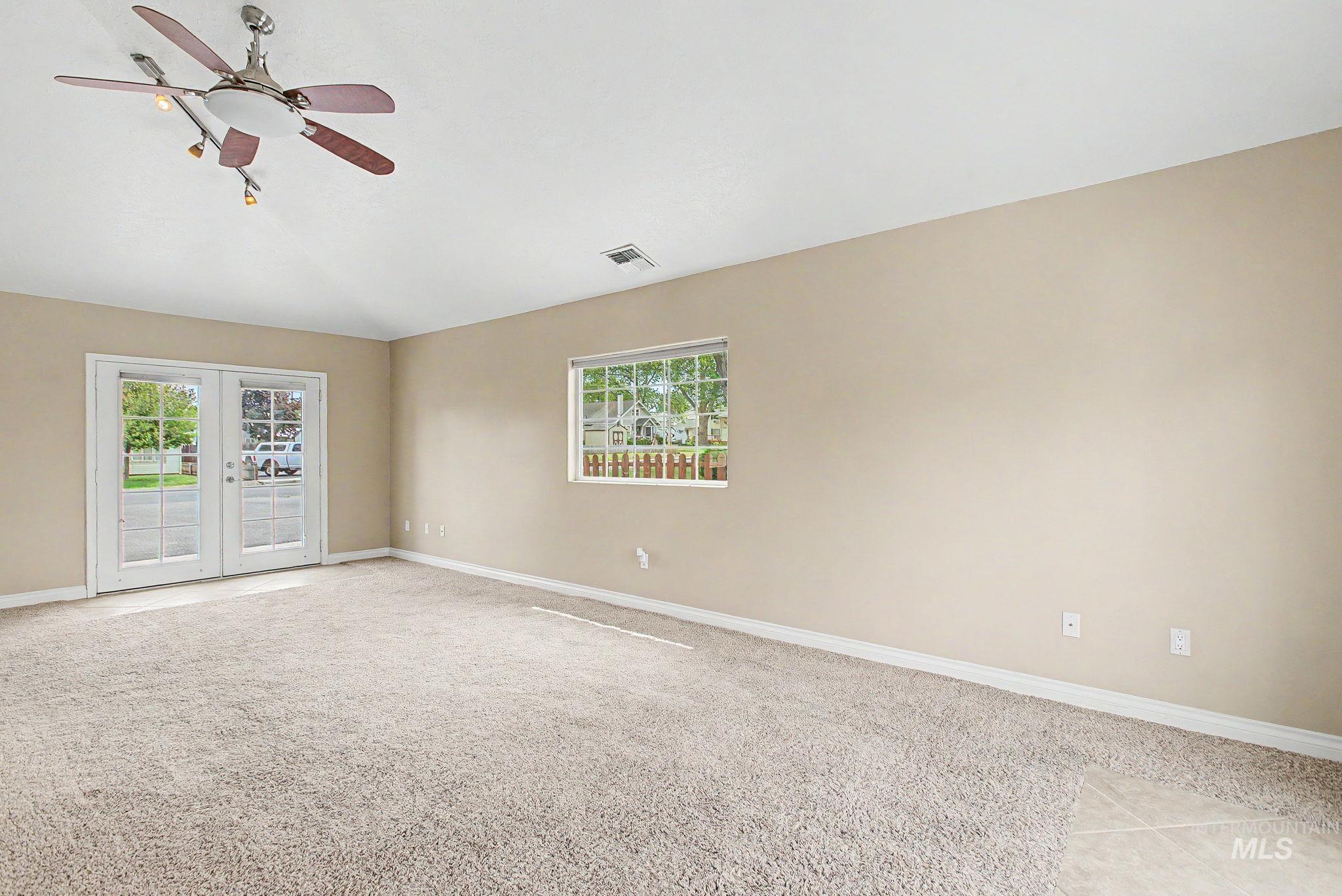 3314 6th Street Lewiston, ID 83501 - Photo 15 of 50 Spacious interior featuring neutral carpeting, a vaulted ceiling, and a ceiling fan with integrated lighting