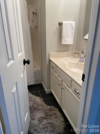 a bathroom with a sink and mirror with toilet