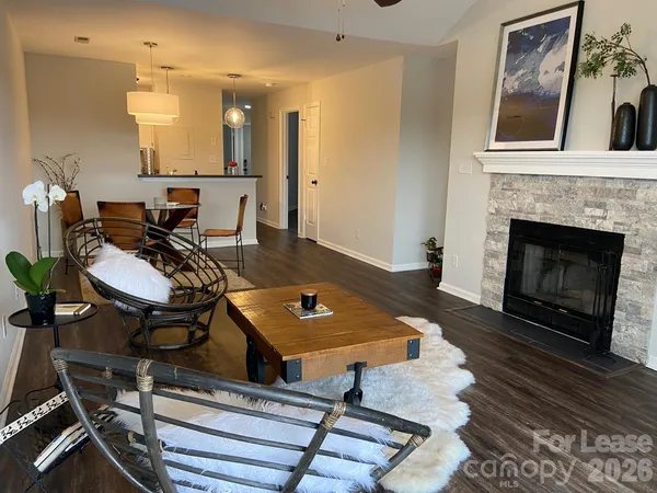 a living room with furniture a fireplace and a table