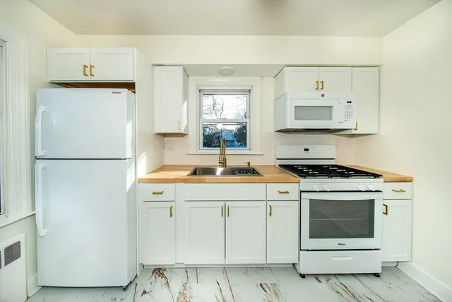 a kitchen with a stove a sink and a refrigerator