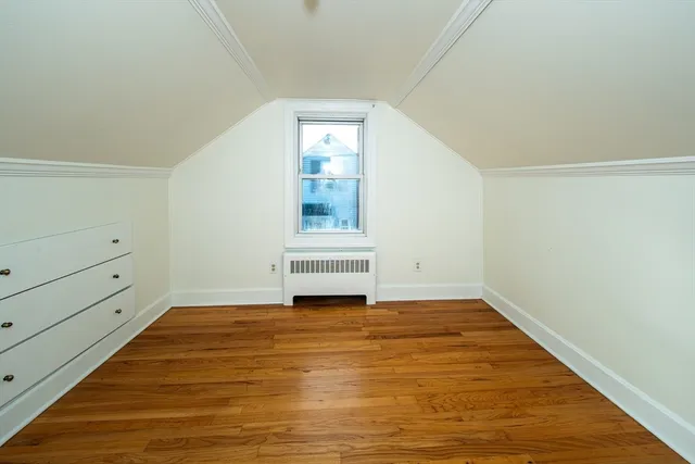 a view of a room with wooden floor and white walls