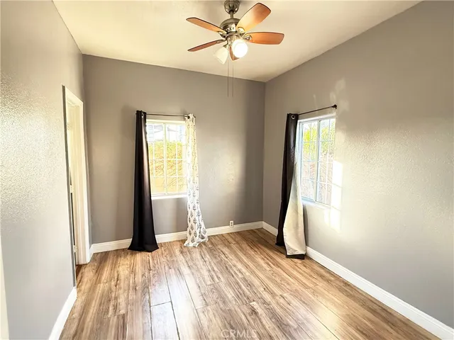 a view of a room with a window and wooden floor